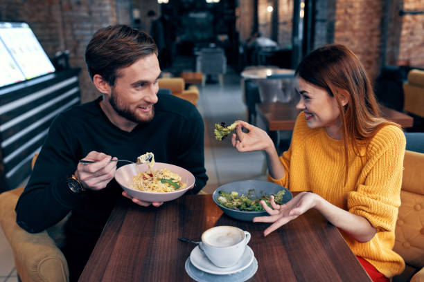 istock man and woman sitting in cafe dinner emotions fun 2120550452
