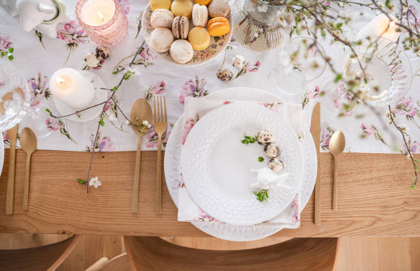 istock Spring Easter decor. Easter table setting. Flowers and dishes and candles for a festive dinner 2120553320