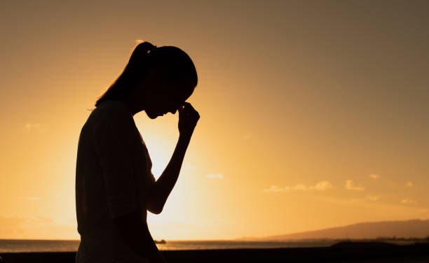 istock Sad woman in sunset settings. 2120559017