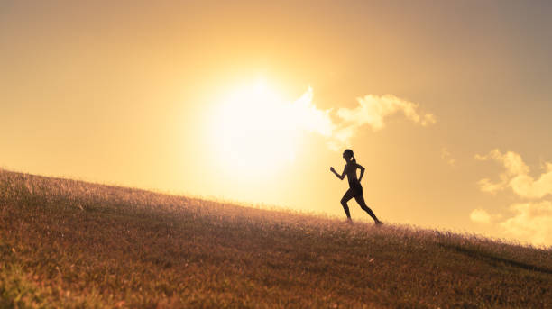 istock Woman running outdoors at sunset. 2120560054
