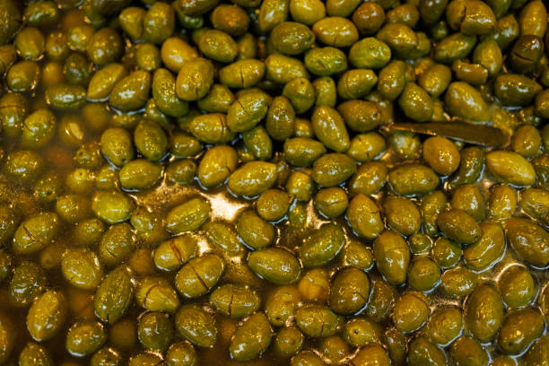 Istanbul, Turkey-February 17, 2024: Green raw crushed olives in Kadikoy Historical Bazaar.