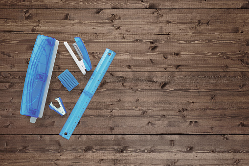 A group of office stationary supply on a wood background
