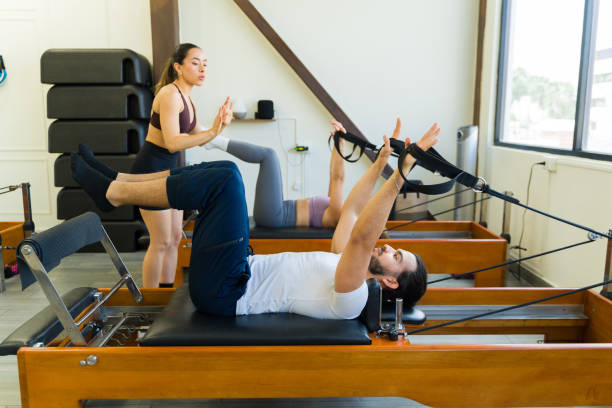 Pilates reformer class in action with a ftiness coach