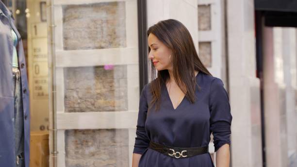 istock Elegant Woman Walking in Urban Spain Setting 2120578445