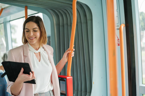 istock Young woman using the tablet to attend to her work issues while on public transport. Concept: lifestyle, business, entrepreneur 2120581567