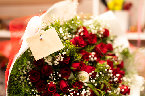 Beautiful red roses with a blank message tag