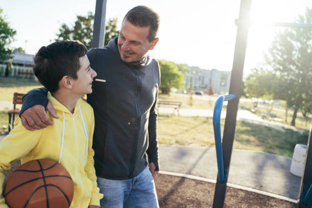 istock Morning Training. Father And Son Playing Basketball. Conversation between father and a son 2120585213