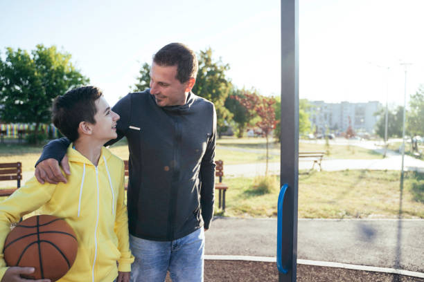 istock Morning Training. Father And Son Playing Basketball. Conversation between father and a son 2120585220