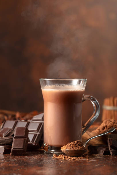 istock Glass of cocoa drink with ingredients on a brown table. 2120600975