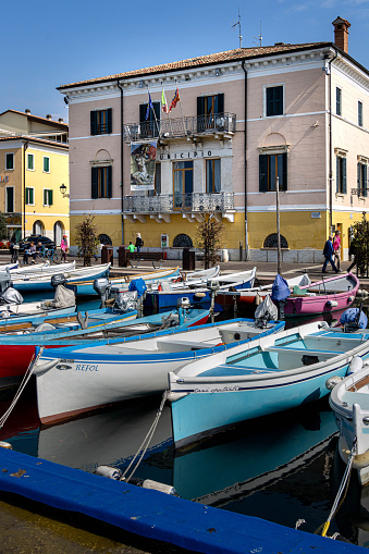 Bardolino, Lake Garda, Italy - 23 March 2024 Colorful fishing boats at harbour of Bardolino