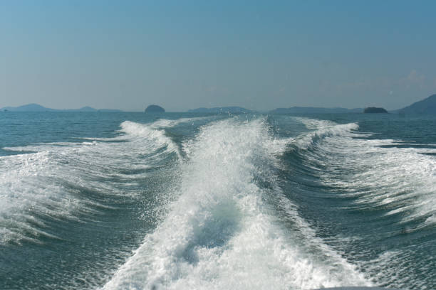 Waves created by speed boat in blue water.