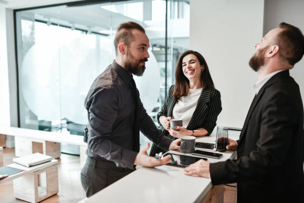 istock Smiling Business Colleagues Hanging Out During Work Break 2120643962