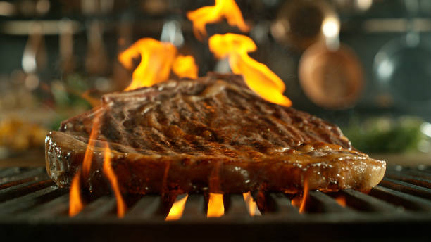 istock Close-up of tasty beef steak on cast-iron grate 2120648140