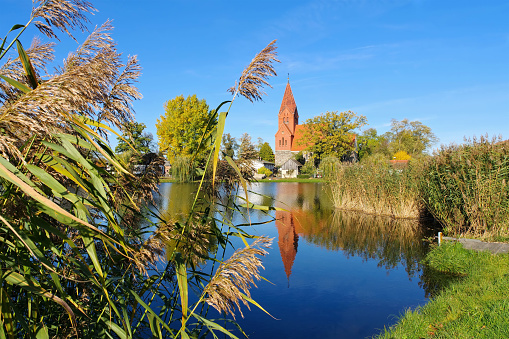 the village Muerow in the Uckermark, old church with pond