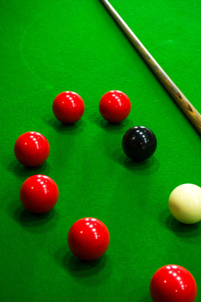 istock pool balls and cuesticks resting on a green table 2120655544