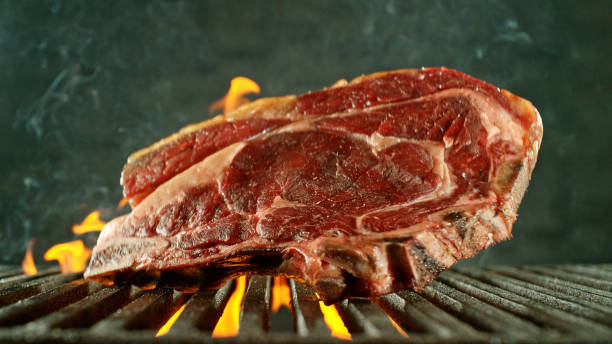istock Close-up of tasty beef steak on cast-iron grate 2120666421
