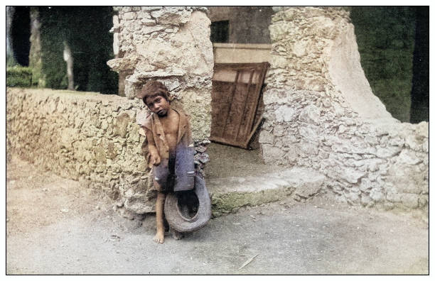 istock Antique black and white photograph: Cuban little boy begging 2120687090