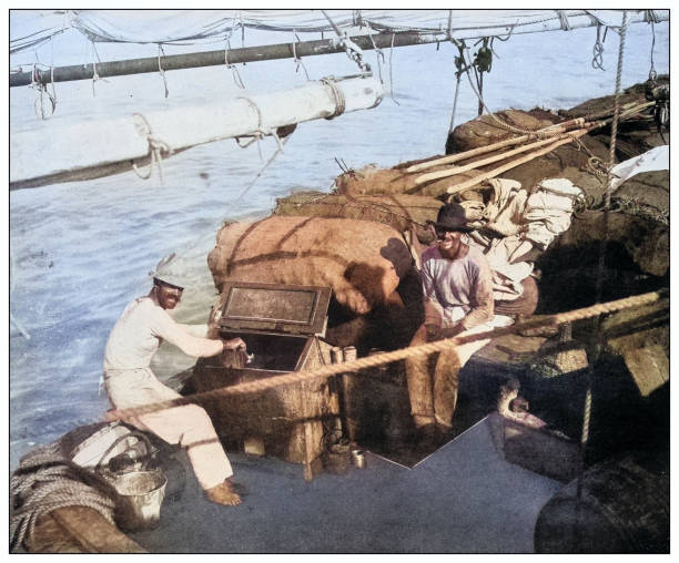 Antique black and white photograph of people from islands in the Caribbean and in the Pacific Ocean; Cuba, Hawaii, Philippines and others: Greek fishing boat, Isla de la Juventud