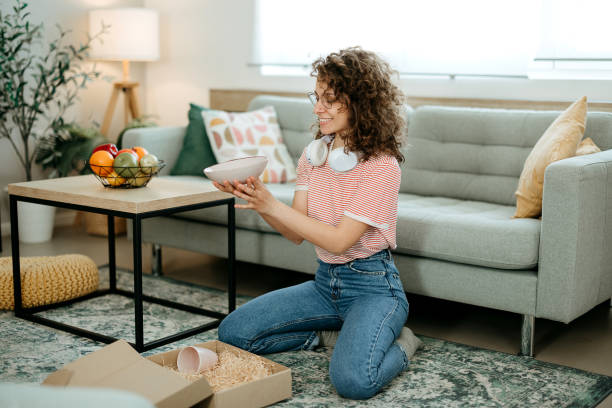 istock Young woman unpacks a package 2120720570