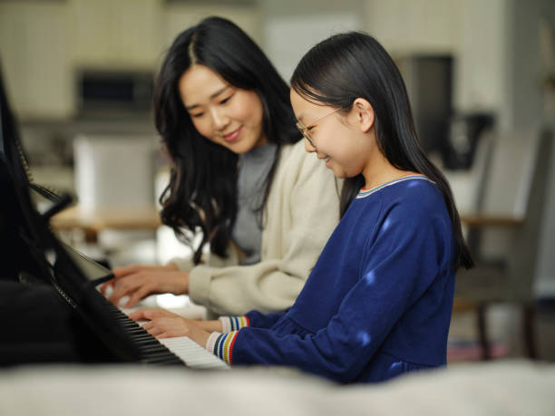 istock Piano Teacher and Student in a Home 2120721065