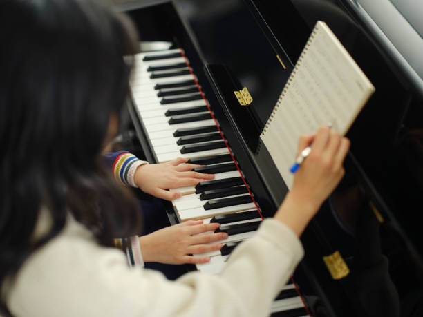 istock Piano Teacher and Student in a Home 2120721172