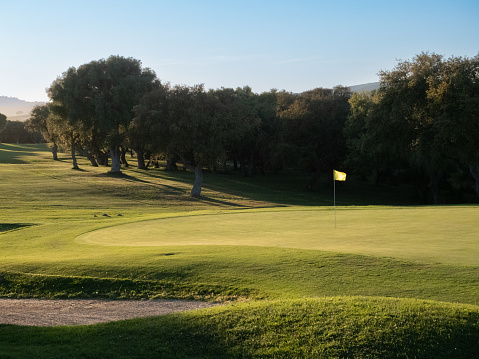 Beautiful golf course in a sunny day. Background evening golf course has sunlight shining down. Golf course in the countryside