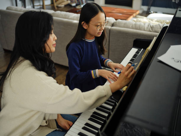 istock Piano Teacher and Student in a Home 2120721203