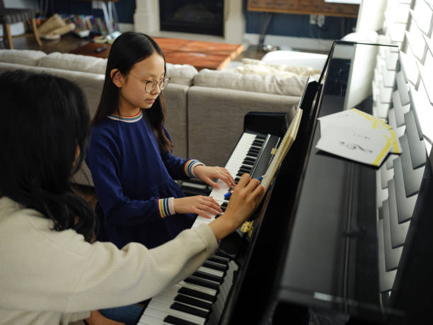 istock Piano Teacher and Student in a Home 2120721231
