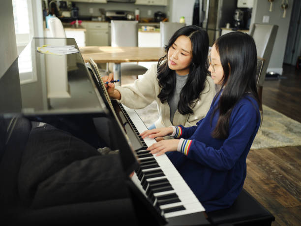 istock Piano Teacher and Student in a Home 2120721318