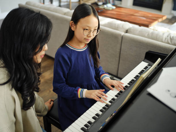 istock Piano Teacher and Student in a Home 2120721360