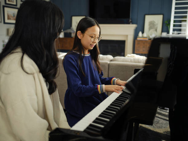 istock Piano Teacher and Student in a Home 2120727028