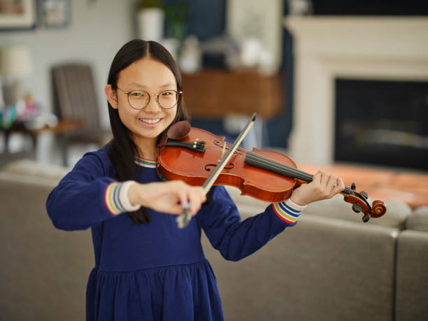 istock Young Girl Practicing Violin in a Home 2120733246