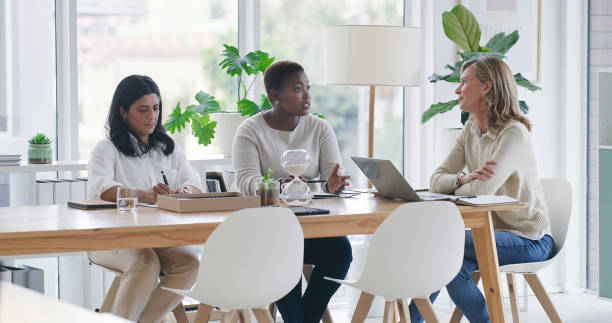 istock Businesswomen, teamwork and meeting in conference room for brainstorming plan, problem solving or collaboration. Female people, notes and research as coworkers at creative agency, project or start up 2120741033