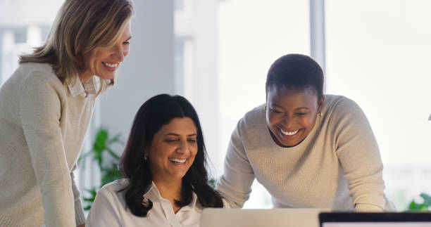 istock Business women, planning and teamwork on computer for editing, collaboration and brainstorming on creative project. Professional group of people, editor or happy employees reading on laptop in office 2120741056