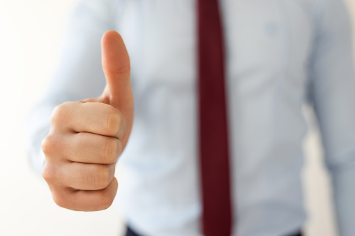 Businessman shows thumbs up