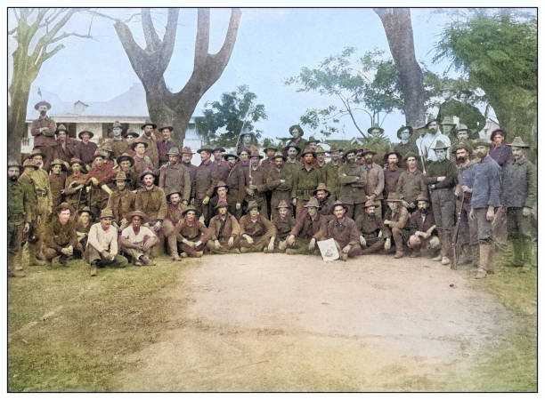 Antique black and white photograph of people from islands in the Caribbean and in the Pacific Ocean; Cuba, Hawaii, Philippines and others: US Artillery, Malolos, Philippines