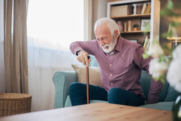 istock Senior man trying to stand up using walking cane 2120758357
