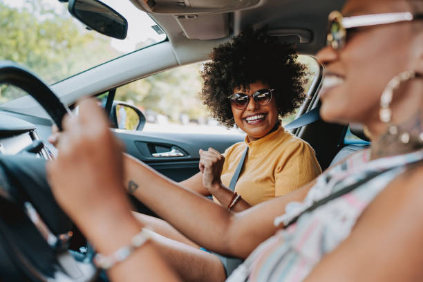 istock Happy friends traveling by car 2120760455