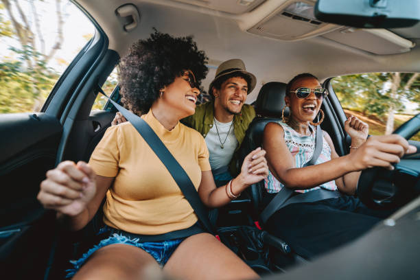 Happy friends traveling by car