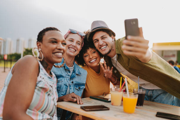 istock Group of friends at table taking selfie 2120762573