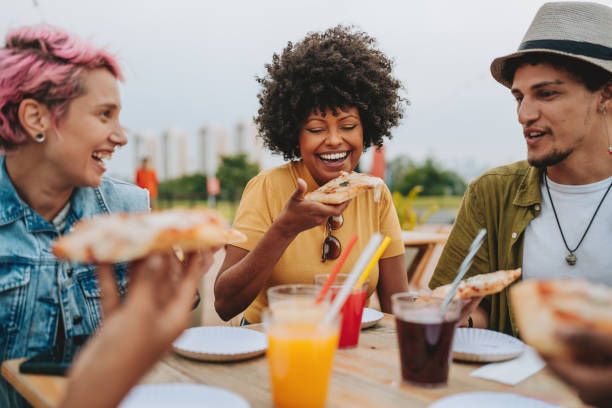 istock Group of friends eating pizza having fun 2120763600