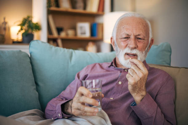istock Senior man taking his pill 2120775044
