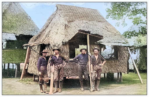 Antique black and white photograph of people from islands in the Caribbean and in the Pacific Ocean; Cuba, Hawaii, Philippines and others:: Soldiers in village, Philippines