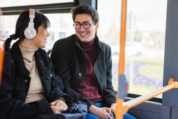 istock Happy young people sharing a laugh on a bus 2120793583