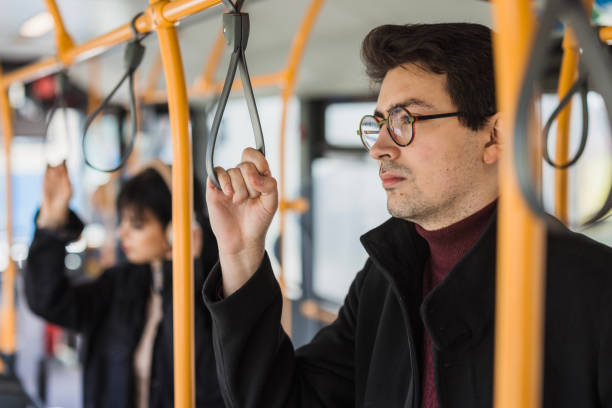 istock Serious student standing in a bus, close-up 2120793807