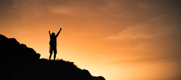 istock Silhouette of man on top a mountain 2120794881