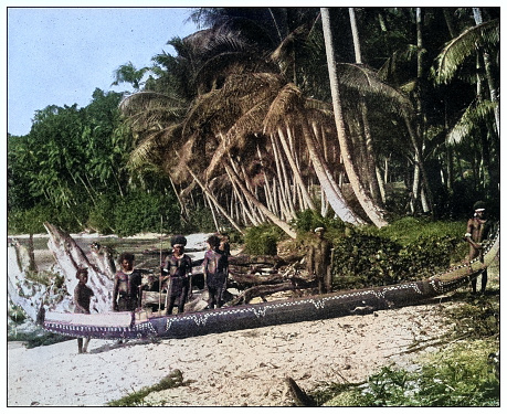 Antique black and white photograph of people from islands in the Caribbean and in the Pacific Ocean; Cuba, Hawaii, Philippines and others: Papuan war canoe