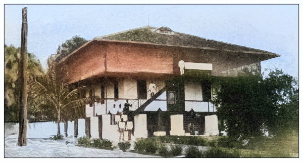 Antique black and white photograph of people from islands in the Caribbean and in the Pacific Ocean; Cuba, Hawaii, Philippines and others: House, San Roque, Philippines