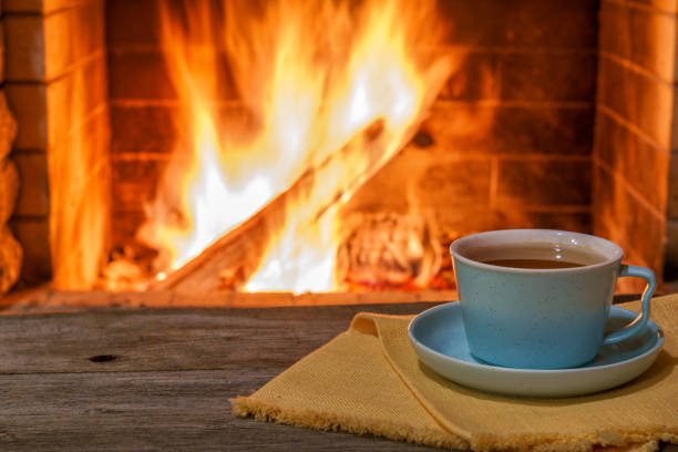 istock Cozy fireplace,winter vacations, a mug of coffee, fire burning 2120838076
