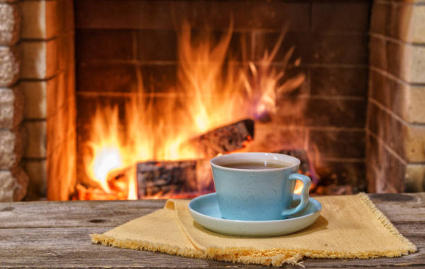 istock Cozy fireplace,winter vacations, a mug of coffee, fire burning 2120838077